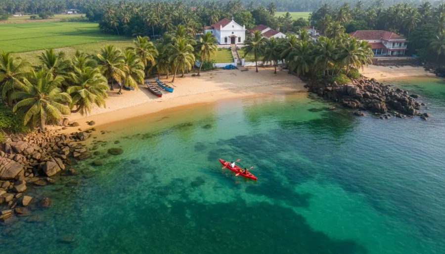 Tandem kayak floating on calm emerald waters in a secluded rocky cove lined with coconut palms.